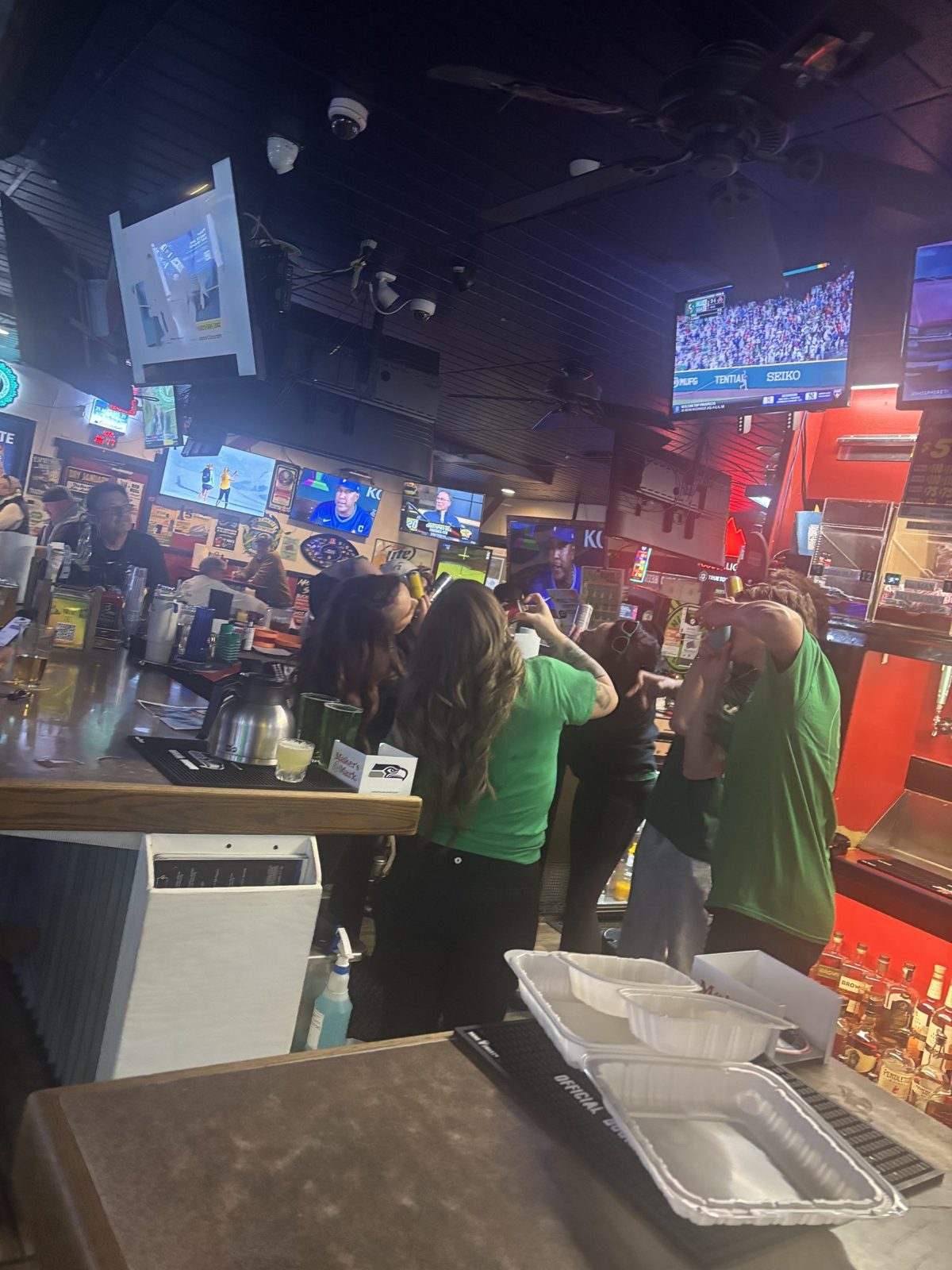 Staff shotgunning Red Bull behind the bar at Sam's Saloon in Kennewick, WA