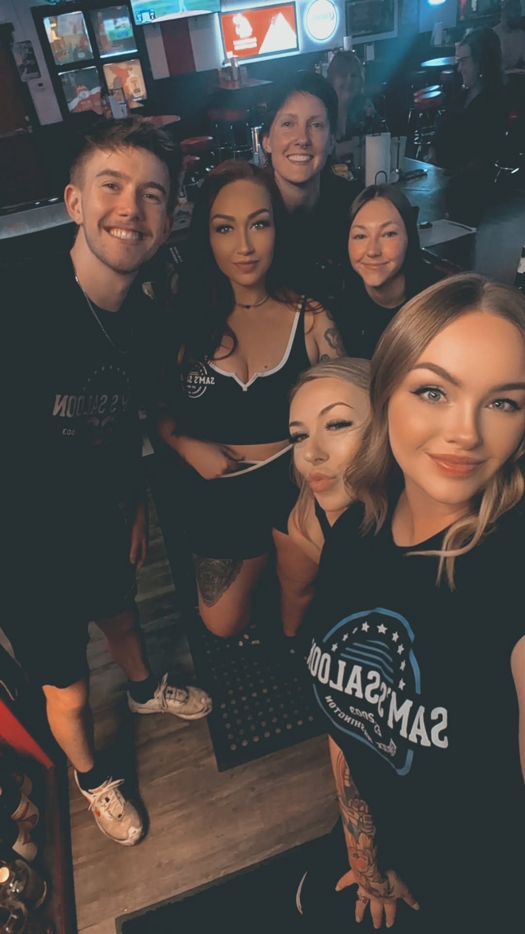 The Sam's Saloon bartenders and servers behind the bar on a busy night in Kennewick, WA